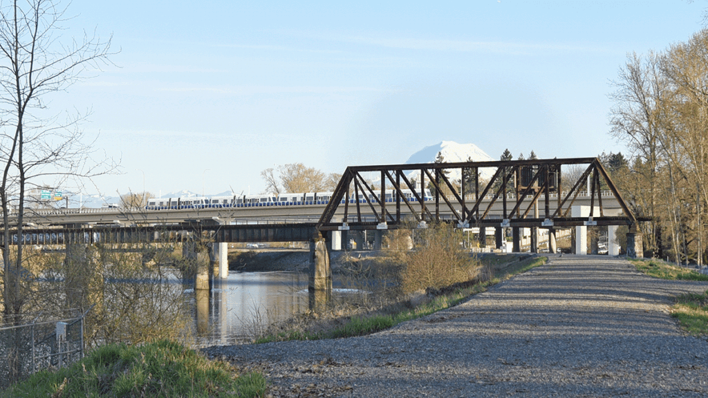 A photorealistic rendering of the proposed pier-supported bridge option across the Puyallup River. The bridge is elevated at a similar height to the existing structure.